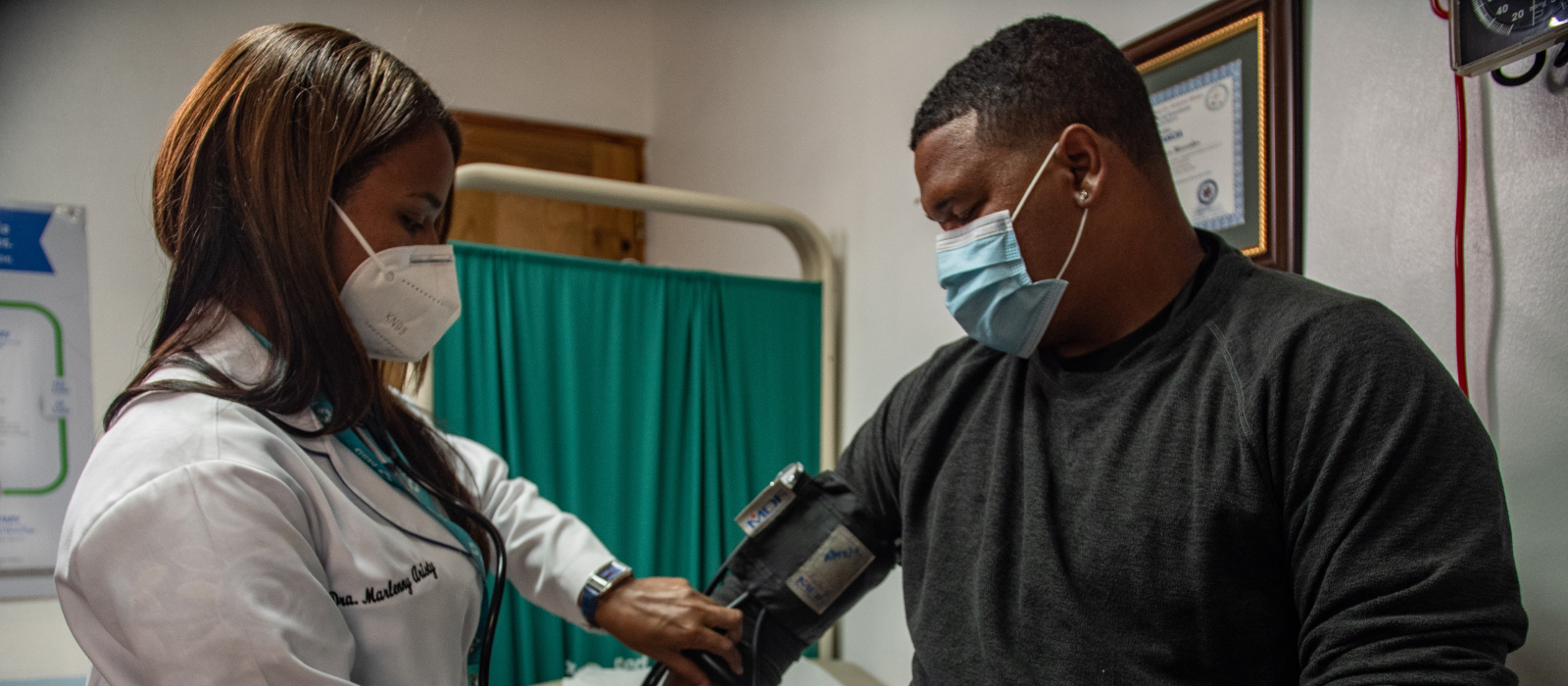 A doctor checking a mans blood pressure