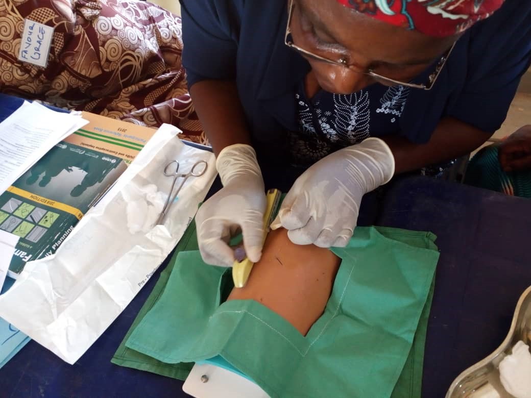 A provider in Nigeria practices inserting an implant into a model arm.