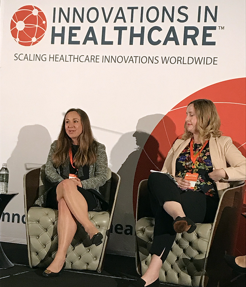 April Warren sitting in a chair in the front of the room during her panel discussion.