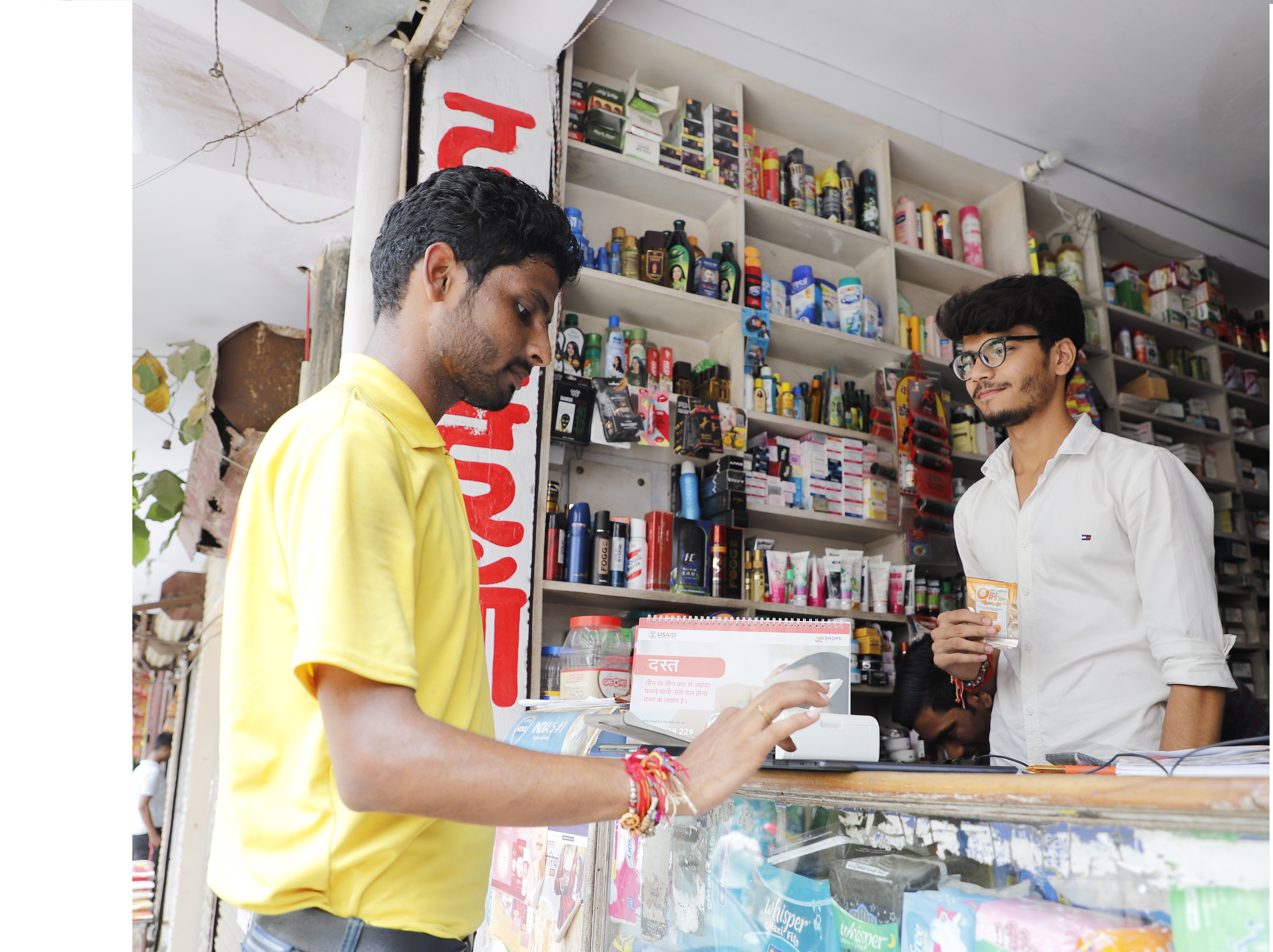 Man at a drug shop talking to a cashier