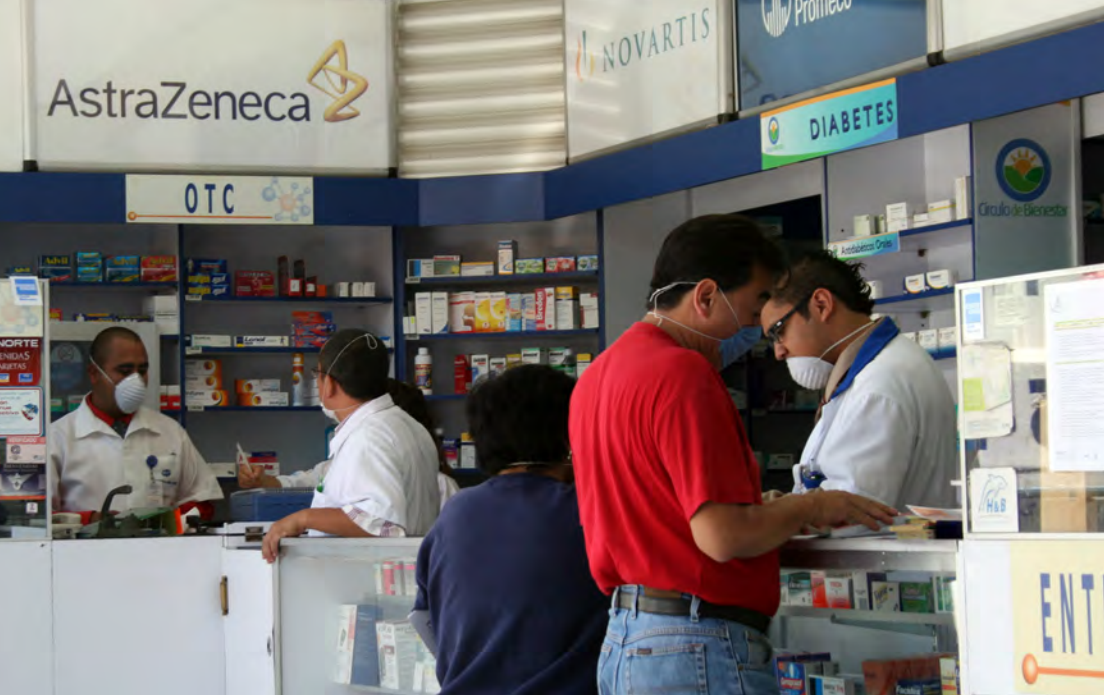 Image of a busy pharmacies with people wearing masks
