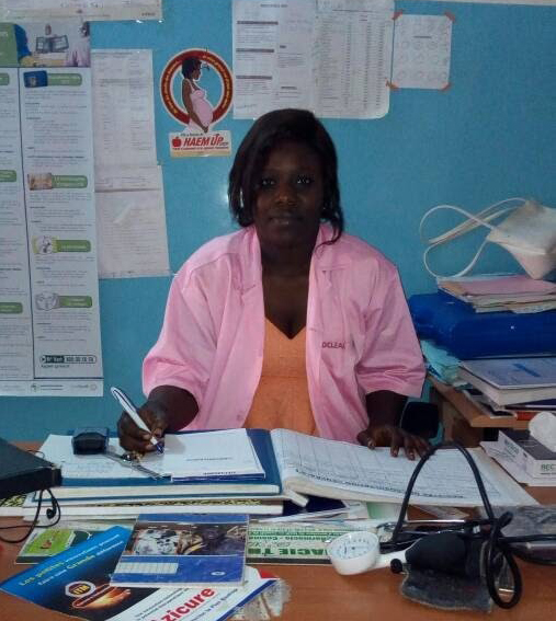 Nurse Ngoné Gueye using one of the ledger books. 