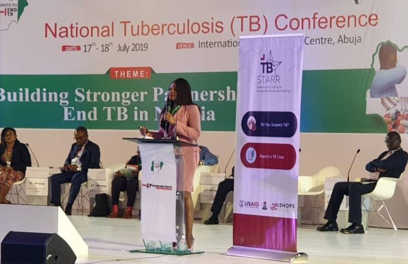 Dr. Bolanle Olusola-Faleye on a stage presenting TB STARR at the National TB Conference
