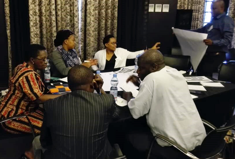 Group sitting around the table at the TMA training in Tanzania. 