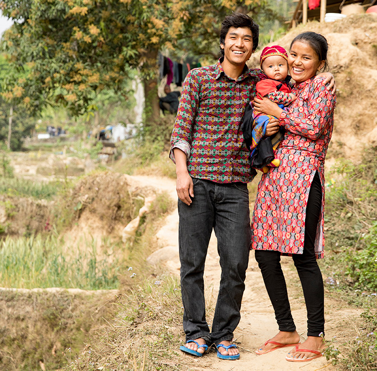 Photo of man and woman holding their baby.