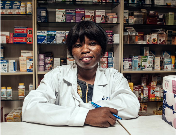 Female pharmacist behind the counter 
