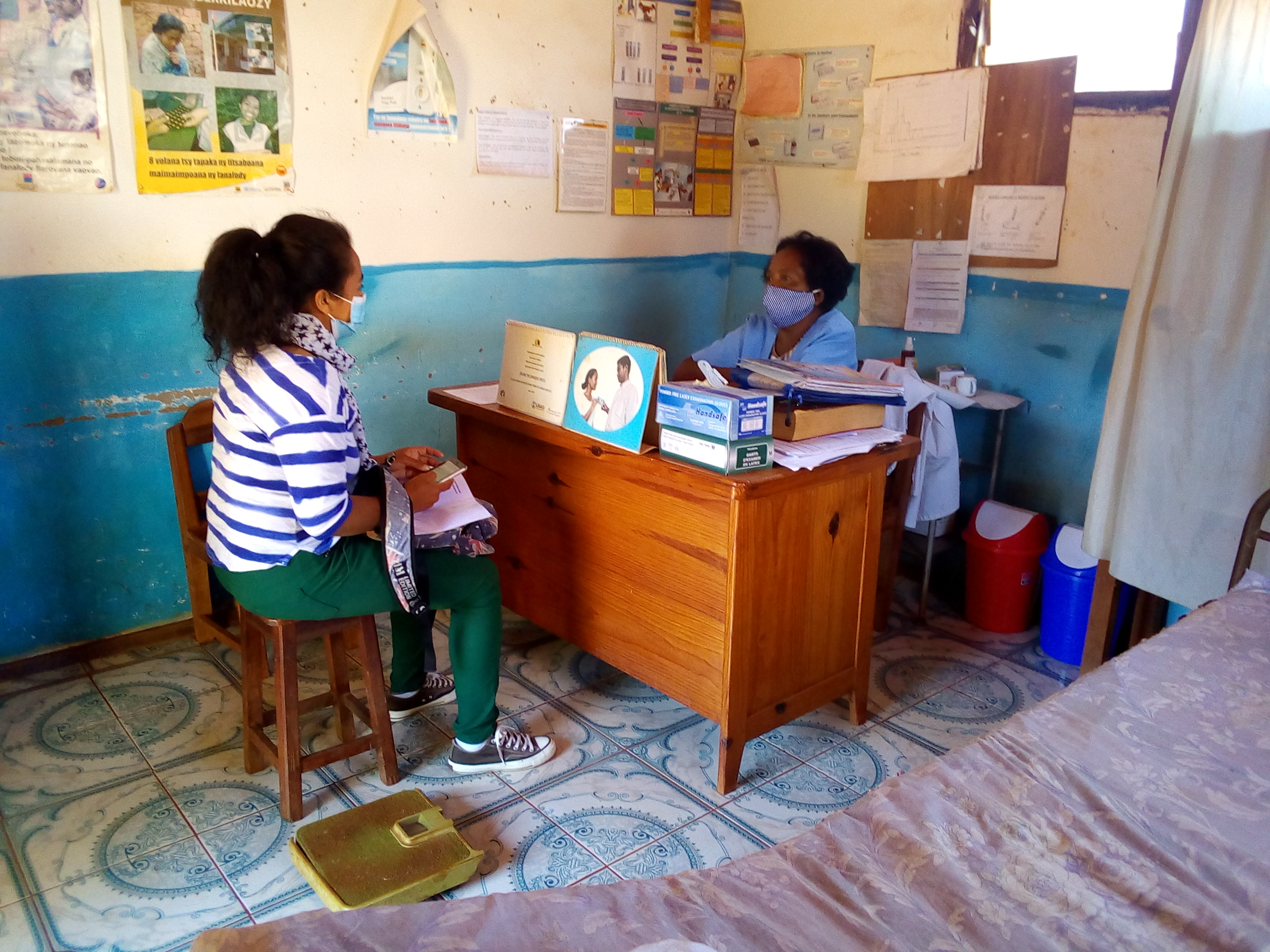 A SHOPS Plus researcher interviews a doctor (right) at EKAR Anjoma clinic in Ambalavao.