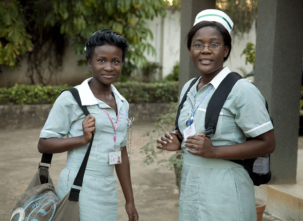 Two nurses standing in uniform. 