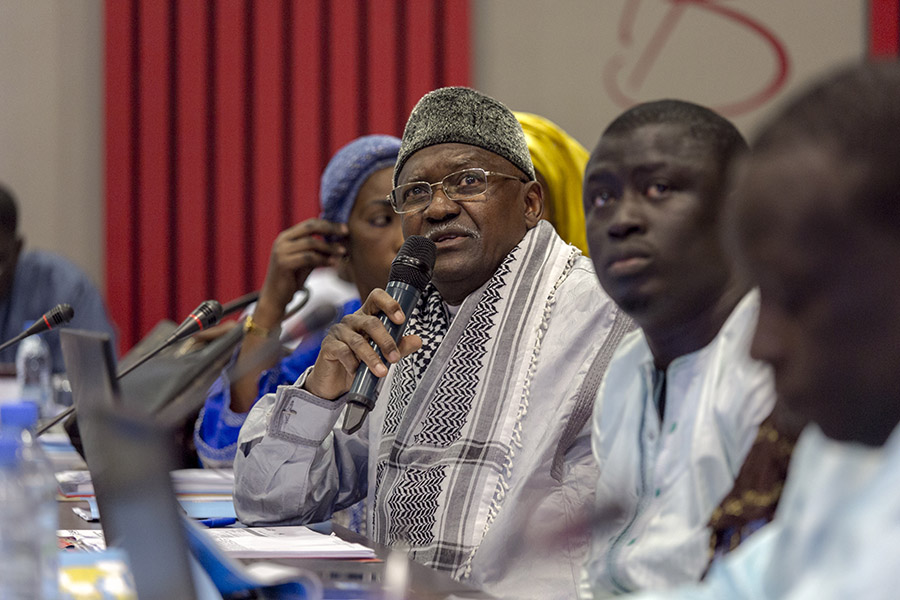 Participant asks question on microphone at the dissemination workshop for the Senegal mapping report