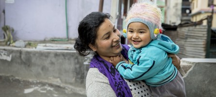 A women holds her child in Nepal.