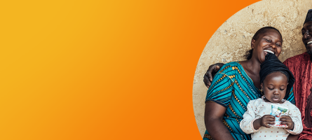 An orange banner with a photo on the right with a married couple laughing while holding their baby