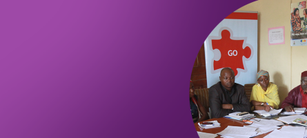 Purple banner image with a photo on the left showing people around a conference table