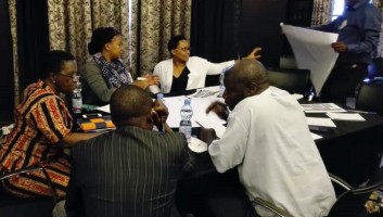 Group sitting around the table at the TMA training in Tanzania. 