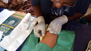A provider in Nigeria practices inserting an implant into a model arm.