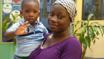 A mother and her young son in a waiting area of a health facility in Cote d'Ivoire
