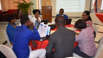A group of participants sitting around a table during a breakout session during the workshop