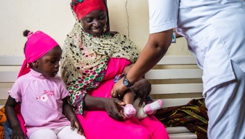A woman with two children and a nurse