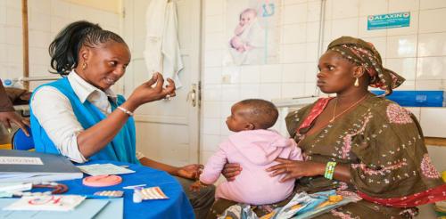 A woman and her baby receive counseling at a Blue Star franchise in Senegal